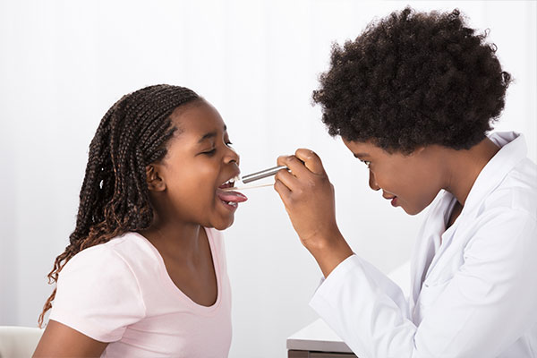 Doctor Examining Child's Throat